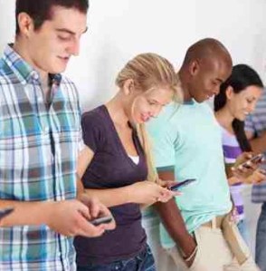 Students texting copyright PixDeluxe iStockPhoto #000014390567 cropped