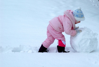 Little Girl Rolling Snowman Phase 1 copyright Jen D iStockPhoto #000001319904
